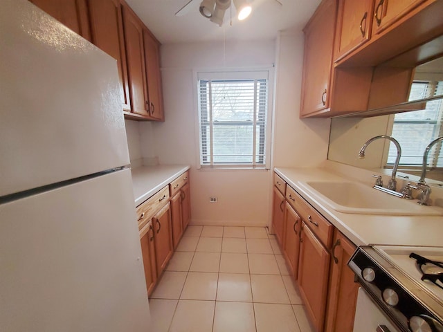 kitchen featuring ceiling fan, sink, light tile patterned floors, and white appliances