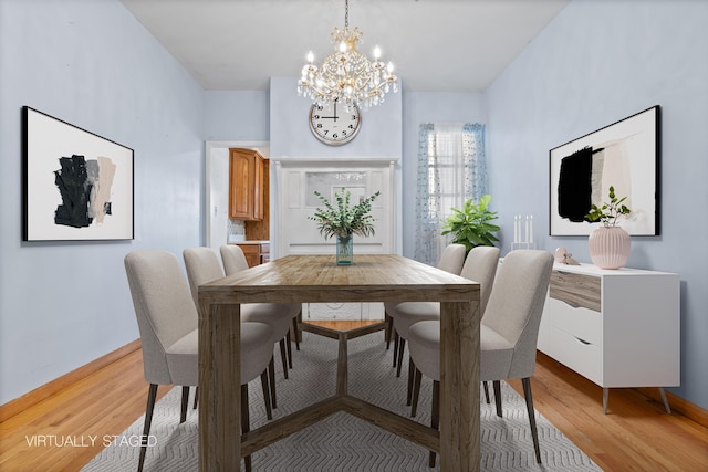 dining area with a notable chandelier and light wood-type flooring