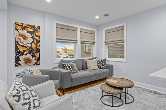 living room featuring baseboards, wood finished floors, visible vents, and recessed lighting