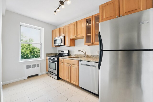 2520 Kennedy Blvd Unit 4J, Jersey City, NJ 07304 - kitchen with stainless steel appliances, radiator heating unit, light stone countertops, glass insert cabinets, and light tile patterned floors