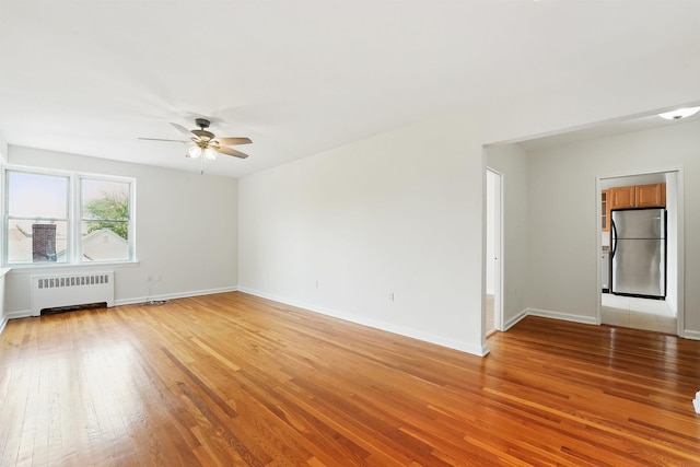 2520 Kennedy Blvd Unit 4J, Jersey City, NJ 07304 - empty room with radiator, ceiling fan, light wood-type flooring, and baseboards