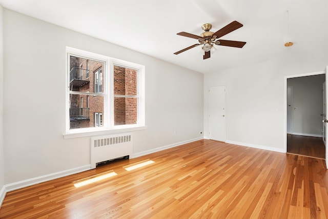 2520 Kennedy Blvd Unit 4J, Jersey City, NJ 07304 - empty room with radiator, a ceiling fan, wood finished floors, and baseboards