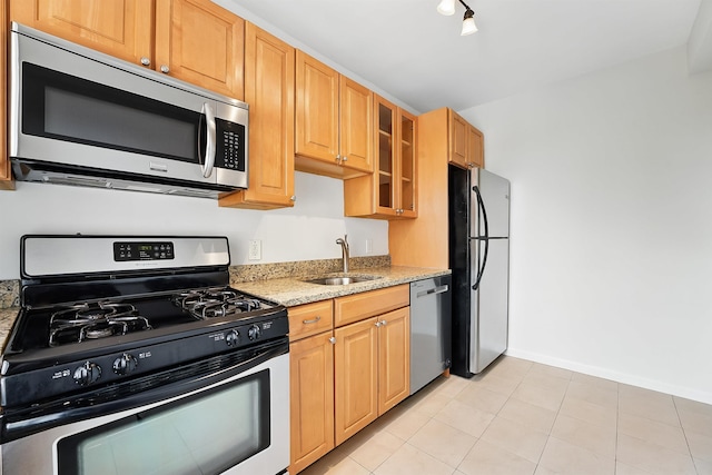 2520 Kennedy Blvd Unit 4J, Jersey City, NJ 07304 - kitchen featuring stainless steel appliances, a sink, light stone countertops, glass insert cabinets, and baseboards