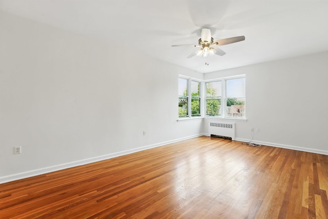 2520 Kennedy Blvd Unit 4J, Jersey City, NJ 07304 - spare room featuring radiator, ceiling fan, light wood finished floors, and baseboards