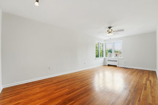 2520 Kennedy Blvd Unit 4J, Jersey City, NJ 07304 - unfurnished room featuring radiator heating unit, a ceiling fan, and wood finished floors