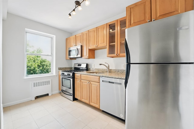 2520 Kennedy Blvd Unit 4J, Jersey City, NJ 07304 - kitchen with appliances with stainless steel finishes, radiator, light stone counters, a sink, and baseboards