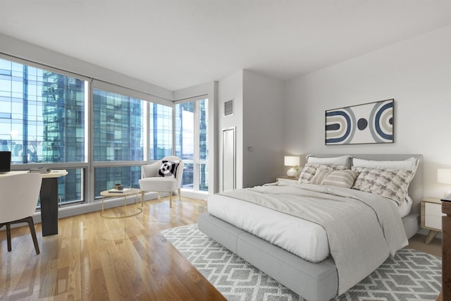 77 Hudson St Unit 1712, Jersey City, NJ 07302 - bedroom featuring wood finished floors and multiple windows