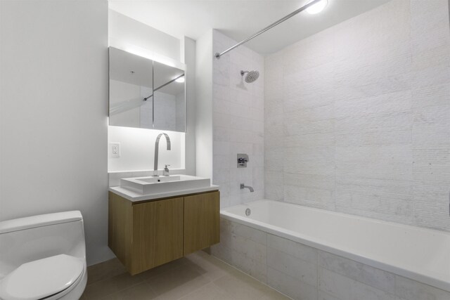 77 Hudson St Unit 1712, Jersey City, NJ 07302 - bathroom featuring toilet, tiled shower / bath combo, vanity, and tile patterned floors
