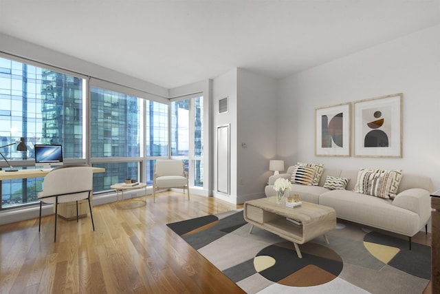 77 Hudson St Unit 1712, Jersey City, NJ 07302 - living area with wood finished floors, plenty of natural light, and baseboards