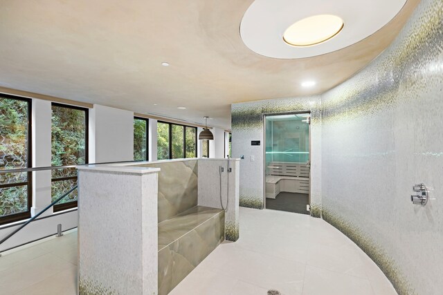 bathroom featuring a wall of windows and tile patterned floors