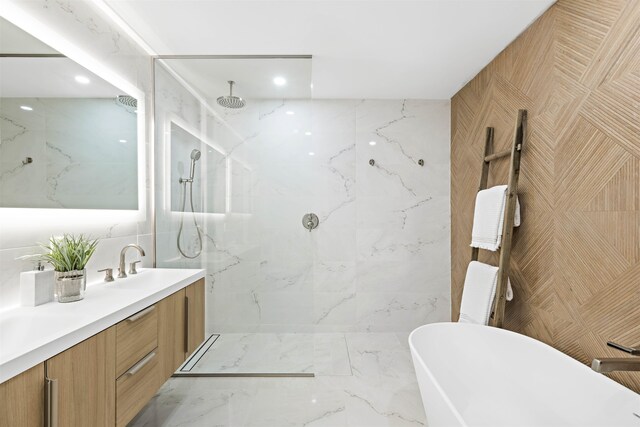 bathroom featuring tile walls, vanity, and shower with separate bathtub