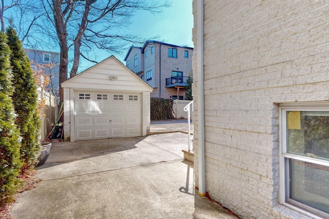 detached garage with driveway and fence