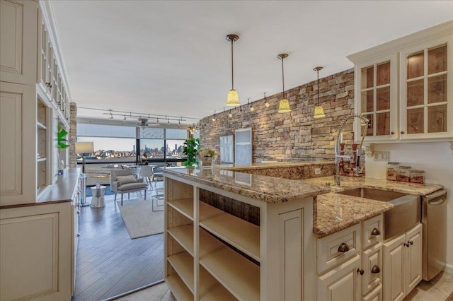 380 Mountain Rd Unit 808, Union City, NJ 07087 - kitchen with cream cabinetry, open floor plan, decorative light fixtures, glass insert cabinets, and light wood-style flooring