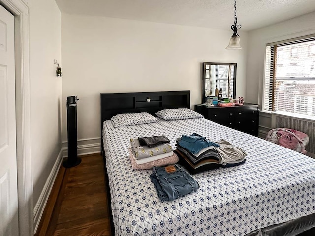 36 Duncan Ave Unit D2, Jersey City, NJ 07304 - bedroom with wood finished floors, baseboards, and a textured ceiling