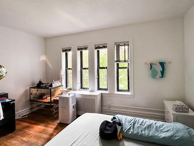 36 Duncan Ave Unit D2, Jersey City, NJ 07304 - bedroom featuring wood finished floors, a textured ceiling, and baseboards