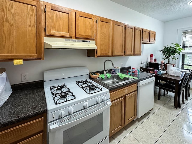 36 Duncan Ave Unit D2, Jersey City, NJ 07304 - kitchen featuring white appliances, under cabinet range hood, a sink, brown cabinetry, and a textured ceiling