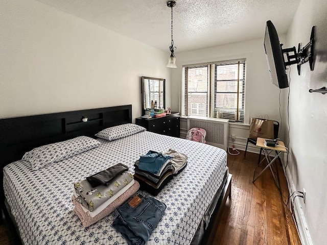 36 Duncan Ave Unit D2, Jersey City, NJ 07304 - bedroom featuring dark wood-style floors, a textured ceiling, and baseboards