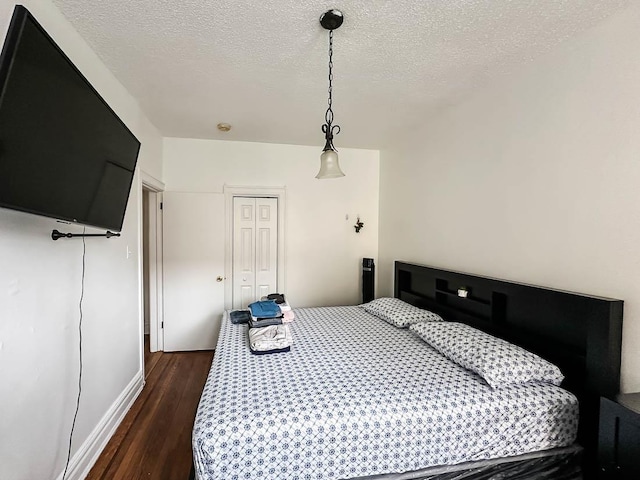 36 Duncan Ave Unit D2, Jersey City, NJ 07304 - bedroom featuring dark wood finished floors, a textured ceiling, and baseboards