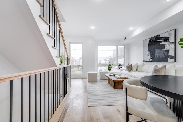 living room with a healthy amount of sunlight and light hardwood / wood-style floors