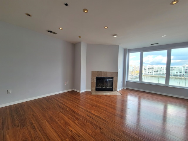 unfurnished living room featuring a fireplace and wood-type flooring