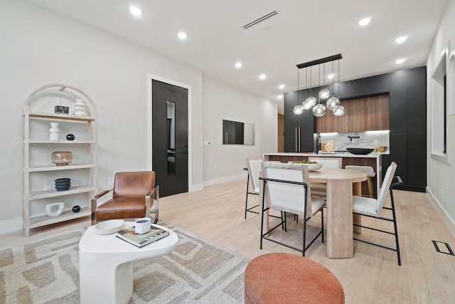 dining space with light hardwood / wood-style floors