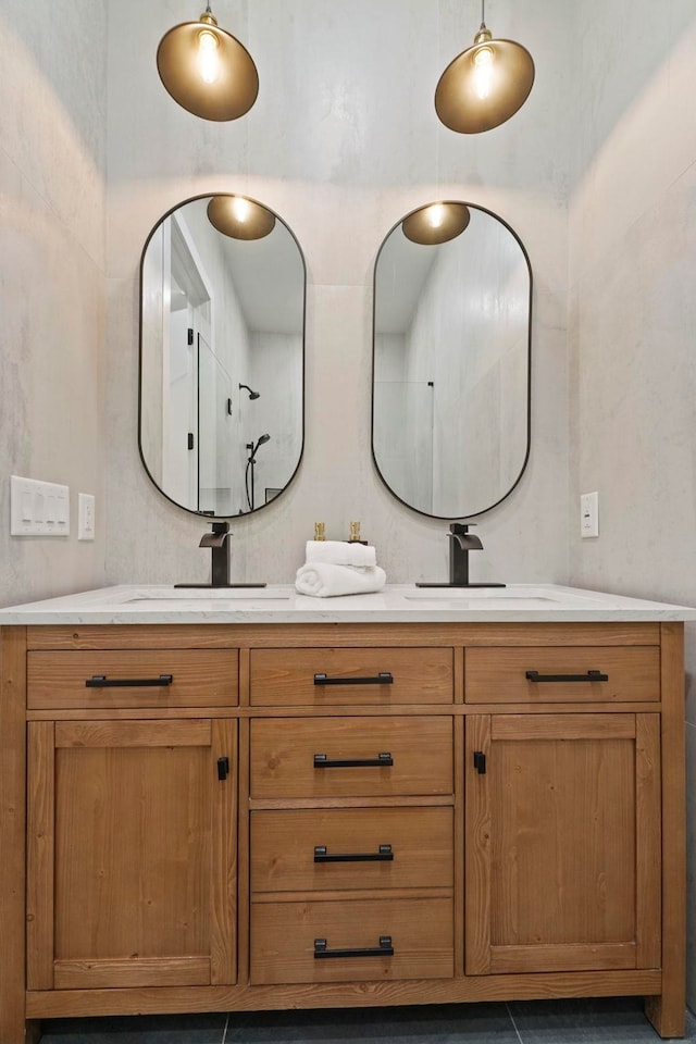 bathroom featuring walk in shower, vanity, and tile patterned flooring