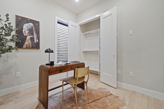 office with light wood-type flooring