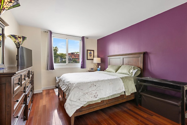 bedroom featuring dark wood-style flooring and baseboards