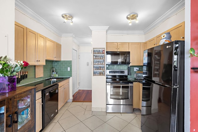 kitchen featuring black appliances, a sink, light brown cabinetry, dark countertops, and crown molding