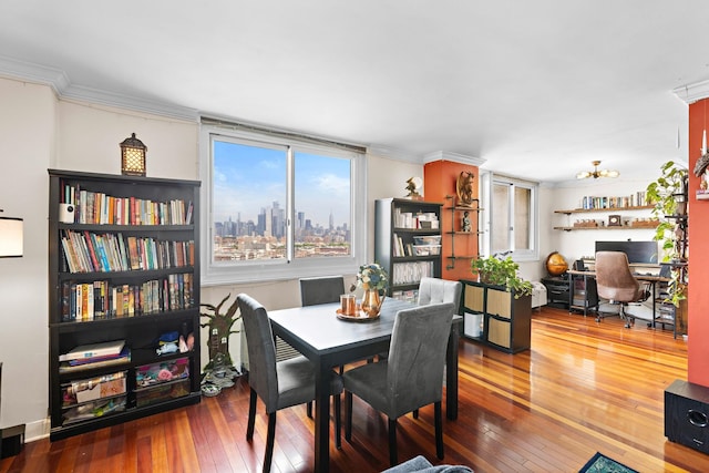 dining space with hardwood / wood-style flooring, ornamental molding, and a desk