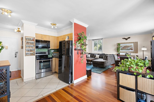 kitchen featuring black appliances, light brown cabinets, baseboards, crown molding, and open floor plan