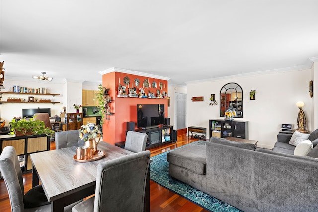 living room with ornamental molding, wood finished floors, and a chandelier