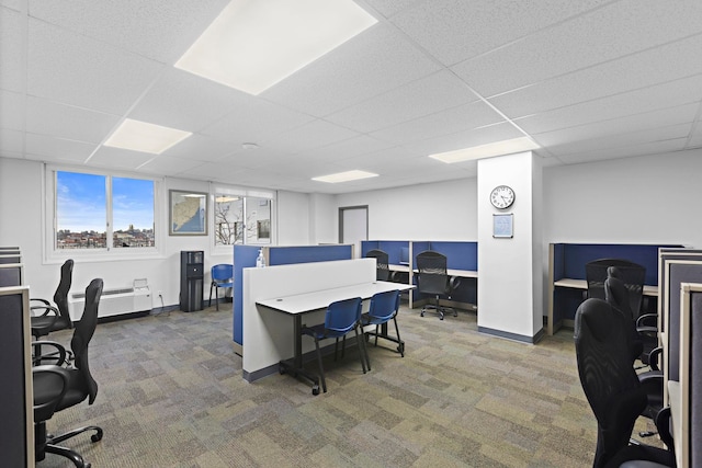 carpeted home office with a paneled ceiling and baseboards