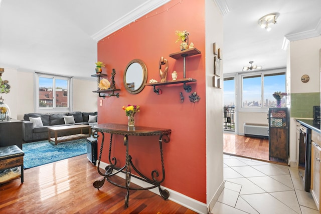 corridor with crown molding, light wood-type flooring, and baseboards