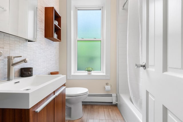 112 Wayne St Unit 2-A, Jersey City, NJ 07302 - bathroom with a baseboard heating unit, healthy amount of natural light, decorative backsplash, and vanity