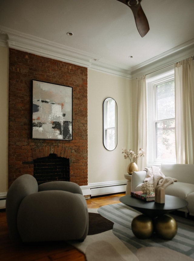 112 Wayne St Unit 2-A, Jersey City, NJ 07302 - living room featuring a baseboard radiator, a fireplace, wood finished floors, ornamental molding, and ceiling fan