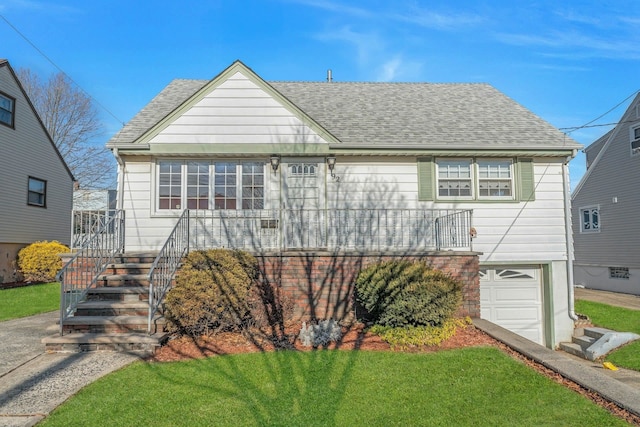 view of front of property with a garage and a front lawn