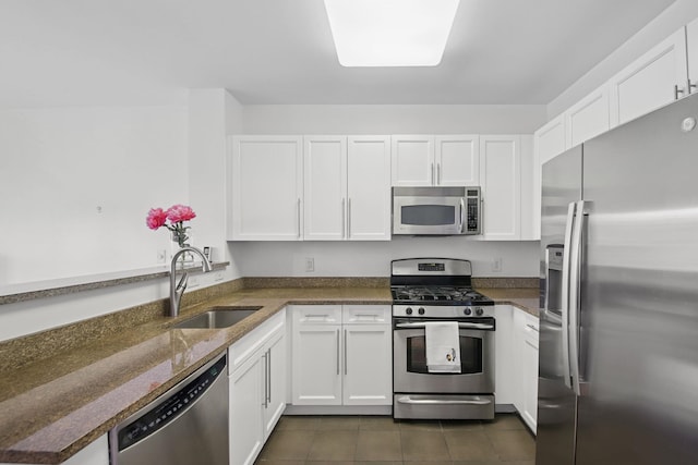 30 Freedom Way Unit 306, Jersey City, NJ 07305 - kitchen with appliances with stainless steel finishes, a sink, white cabinetry, and dark tile patterned floors