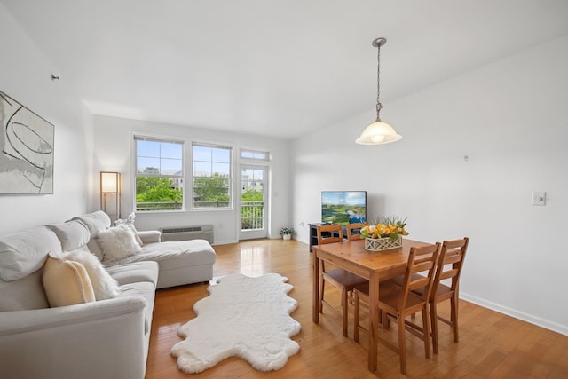30 Freedom Way Unit 306, Jersey City, NJ 07305 - living room featuring light wood-style flooring, a wall mounted AC, baseboards, and lofted ceiling