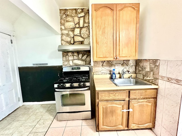 306 Columbia Ave, Jersey City, NJ 07307 - kitchen with gas stove, exhaust hood, light countertops, and light tile patterned flooring