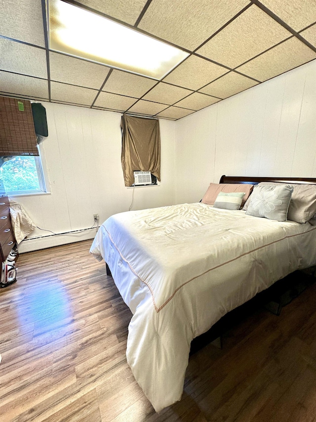 306 Columbia Ave, Jersey City, NJ 07307 - bedroom with a baseboard heating unit, a drop ceiling, wood finished floors, and cooling unit