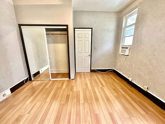 306 Columbia Ave, Jersey City, NJ 07307 - unfurnished bedroom with cooling unit, wood finished floors, and a closet