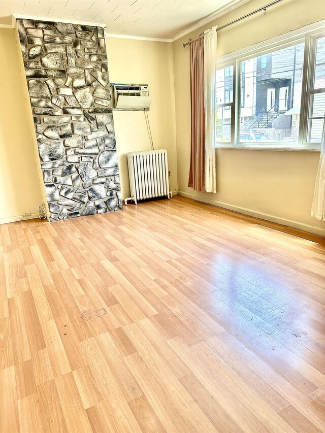 306 Columbia Ave, Jersey City, NJ 07307 - empty room featuring radiator, ornamental molding, a wall unit AC, and wood finished floors