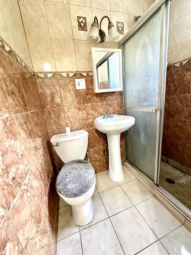 306 Columbia Ave, Jersey City, NJ 07307 - bathroom with a shower stall, tile patterned floors, and tile walls