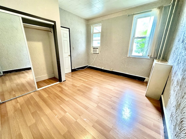 306 Columbia Ave, Jersey City, NJ 07307 - unfurnished bedroom with a textured wall, wood finished floors, cooling unit, and a closet