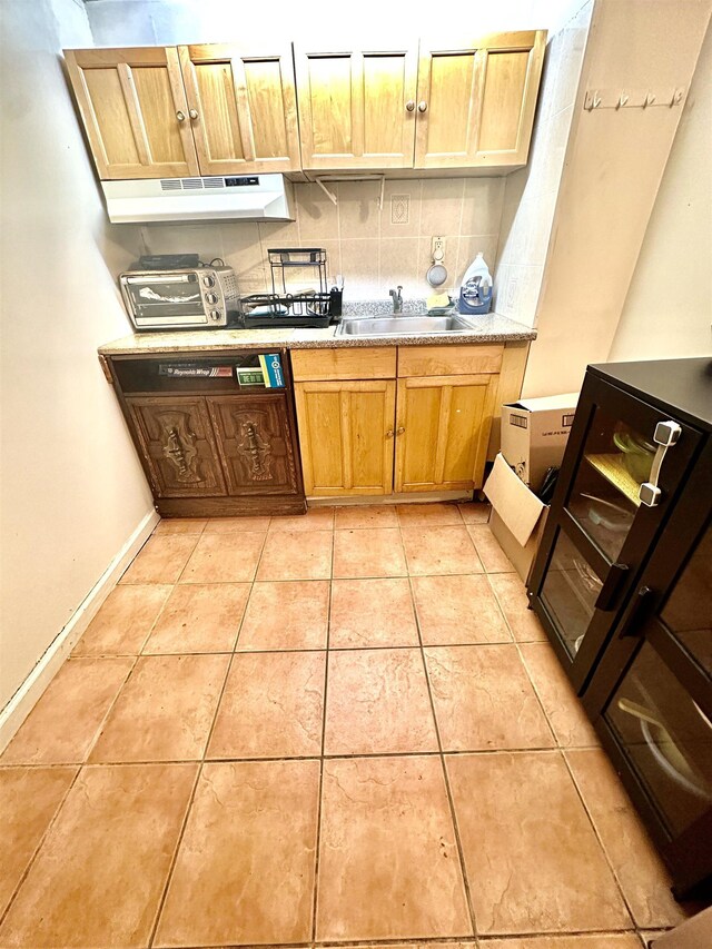306 Columbia Ave, Jersey City, NJ 07307 - kitchen with under cabinet range hood, backsplash, light countertops, and light tile patterned floors