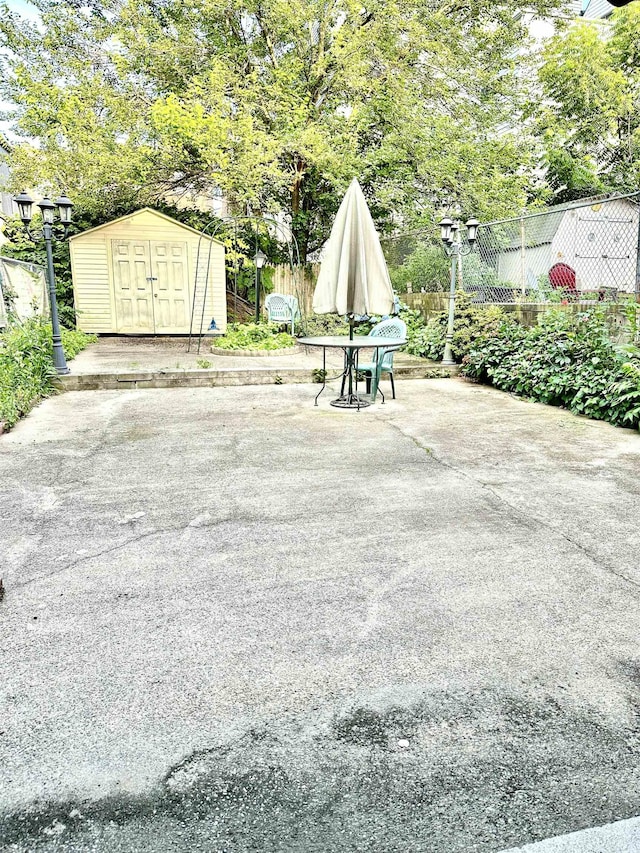 306 Columbia Ave, Jersey City, NJ 07307 - view of patio featuring a storage shed and view of scattered trees