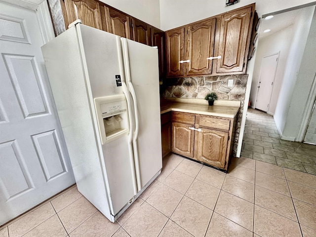 306 Columbia Ave, Jersey City, NJ 07307 - kitchen with white fridge with ice dispenser, light countertops, decorative backsplash, and light tile patterned flooring
