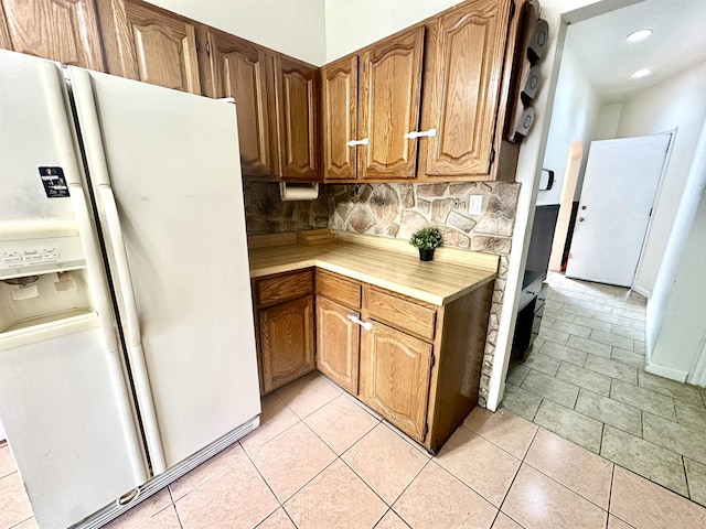 306 Columbia Ave, Jersey City, NJ 07307 - kitchen with white fridge with ice dispenser, light countertops, backsplash, recessed lighting, and brown cabinetry