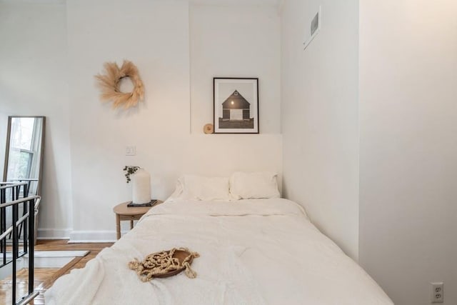 bedroom with wood finished floors